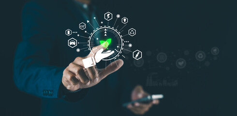 A person interacts with a futuristic digital interface displaying eco-friendly technology icons and a green leaf symbol.