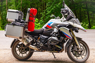 Side view of a motorcycle with a boxer engine, wheel, tires.