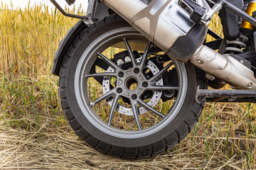 Side view of a motorcycle with a boxer engine, wheel, tires.