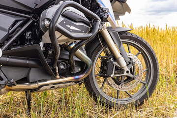 Side view of a motorcycle with a boxer engine, wheel, tires.