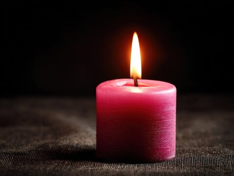 Pink candle flame glowing in a dark room. Hope, remembrance, and tribute for breast cancer awareness month. Memorial visuals and emotional healthcare campaign. Charity, wellness, and tribute marketing