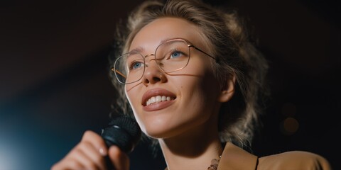 Smiling caucasian female adult giving speech with microphone