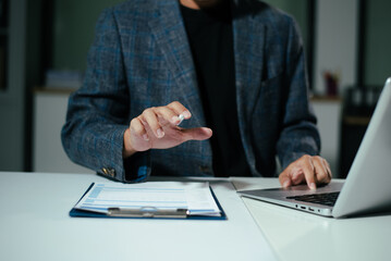 Businessman using on smartphone and tablet and laptop at officeBusinessman using on smartphone and tablet and laptop at office