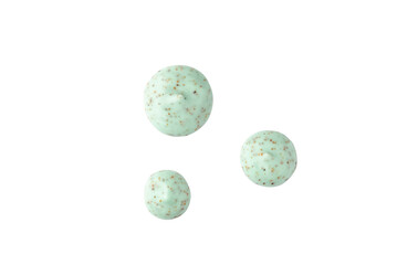 Drops of a green body scrub with particles on a transparent background.