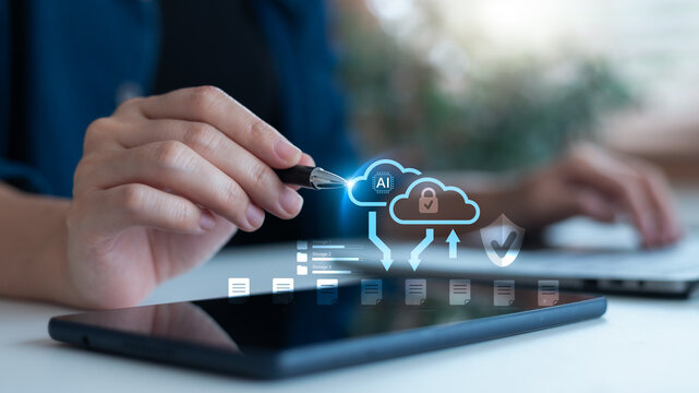 Close-up of hand using stylus on tablet with AI cloud computing interface and secure data upload, symbolizing artificial intelligence, cloud storage and cybersecurity technology.