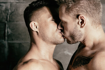 Young attractive gay couple kissing and hugging. Romantic relationship on honeymoon.