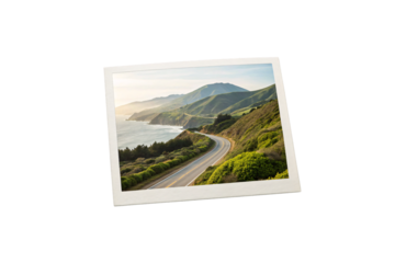 Scenic coastal highway winding through green hills overlooking ocean with mountains in distant background, isolated on a transparent background
