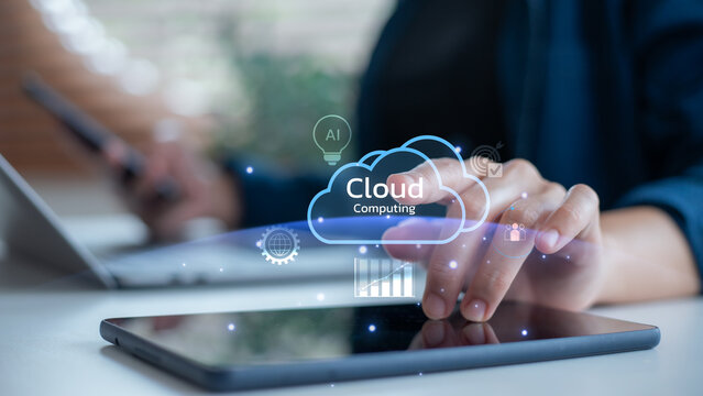 Close-up of a hand using cloud computing digital interface on tablet, with icons of AI, data analytics, and connectivity, concept of modern business technology and innovation.