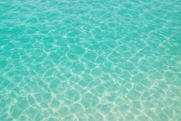 Obraz premium Crystal-Clear Turquoise Waters A Serene View of the Ocean's Refreshing Surface with Reflections