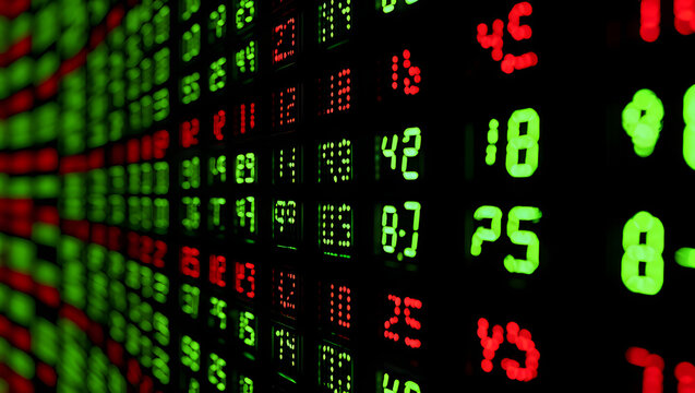Digital stock market ticker board with green and red numbers