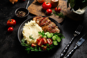 Deliciously Grilled Chicken Breast Slices Served with Mashed Potatoes and Salad