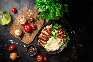 Deliciously Grilled Chicken Breast Slices Served with Mashed Potatoes and Salad