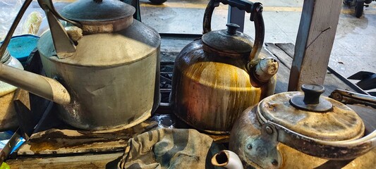 
a stell iron kettle on traditional angkringan