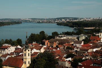 Wide panoramic view of Zemun with churches and red roofs along the Danube, Belgrade visible in the...