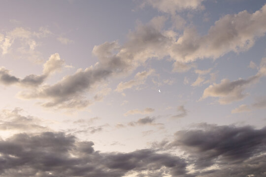 Dark Purple Cloudy sky with small crescent moon