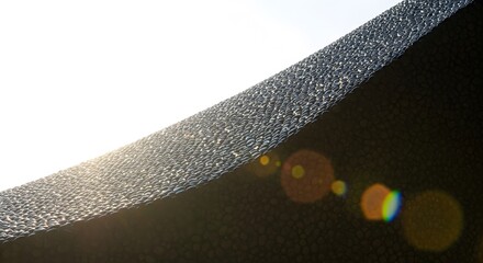 Textured Dark Wall with Sunlight and Lens Flare Abstract Architecture