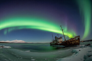 aurora borealis over the sea with old ship
