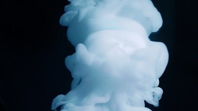 A stream of smoke descends onto a mirror surface, forming a beautiful cloud with circular diverging waves on a black background. Closeup. Macro. Slow mo, slow motion, high speed camera, 200fps
