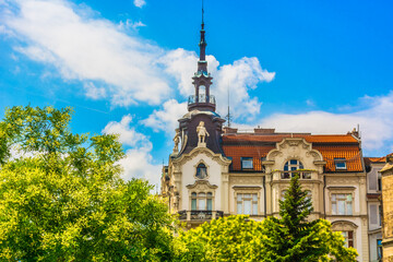 Street-level view of beautifully preserved architectural buildings featuring detailed facades,...