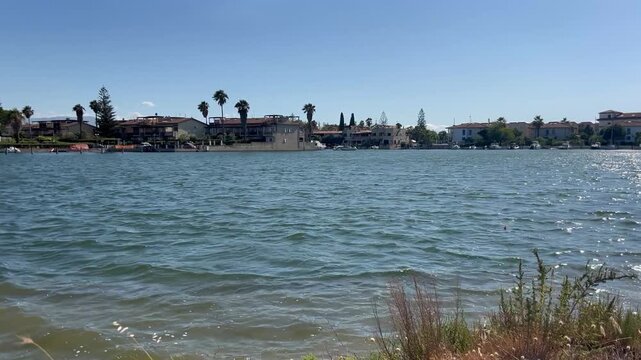 the waters of the Sibari lakes and the residences on the other shore