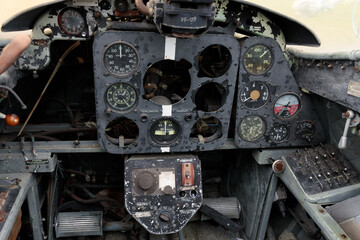 Cockpit of a Rusty Airplane with Detailed Instrument Panel Showing Aging and Damage, Offering a Glimpse into Aviation History and the Passage of Time in Aircraft Technology