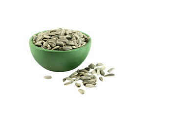 a green bowl filled with sunflower seeds