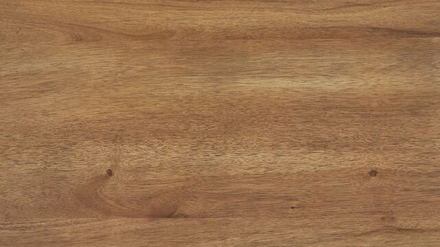 Camera zooms slowly, revealing fine wood grain across tabletop