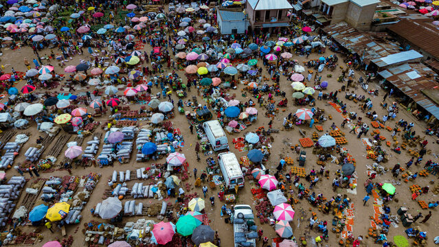 Aerial view of a bustling market scene with colorful umbrellas and diverse stalls creating a vibrant tapestry of commerce, Farin Gada Road, Jos, Plateau, Nigeria.