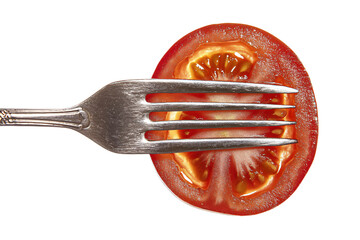 a fork and a tomato cut in half