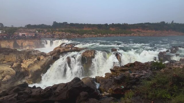 pan shot of of Dhuandhar water falls of narmada river at marble rocks of bhedaghat jabalpur in madhya pradesh india