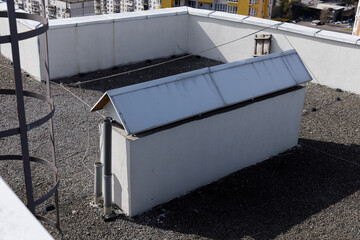 A View of a Rooftop Featuring a White Structure with a Metal Roof, Surveillance Features, and...