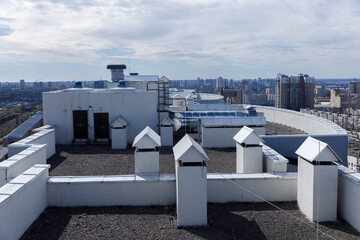Overview of a Rooftop Featuring Ventilation Structures and Urban Landscape in a Modern Cityscape...
