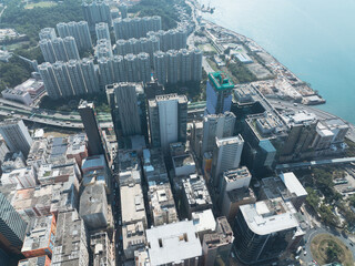 Fototapeta premium Aerial view of central Hong Kong, China, showcasing dense urban buildings and cityscape near the coast. High-rise structures dominate the scene.
