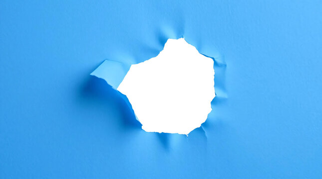 Ripped transparent hole in blue paper