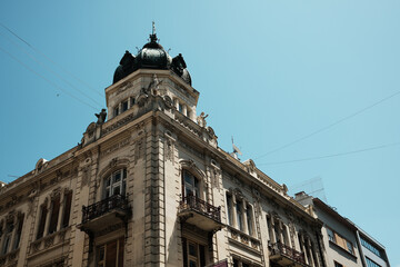 Prometna Banka building in Belgrade with sculpted statues and dome tower, featuring classic European architectural style.