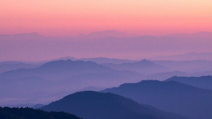 Fototapeta premium Layered mountain ranges under a pink and purple sky at dusk creating a serene and peaceful landscape view