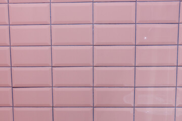 Series of Smooth, Glossy Pink Ceramic Tiles Forming a Uniform Pattern, Creating a Calming Aesthetic for Interior Spaces or Home Designs