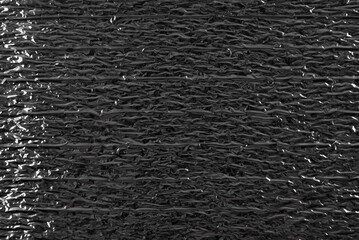 Texture of crumpled silver foil. Foil with dents, folds and wrinkles