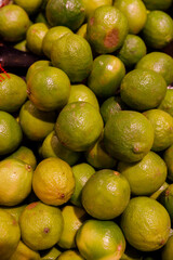 A Fresh Pile of Lush Green Limes and Yellow Limes Ready for Culinary Delights and Refreshing Beverages in a Vibrant Market Setting