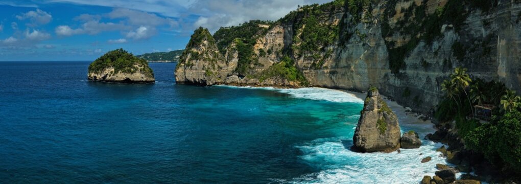 Drone aerial view of Diamond Beach, Nusa Penida, Bali. Captured in June 2025, this image showcases the dramatic limestone cliffs, turquoise waters, and white sand shoreline of this iconic Indonesian b