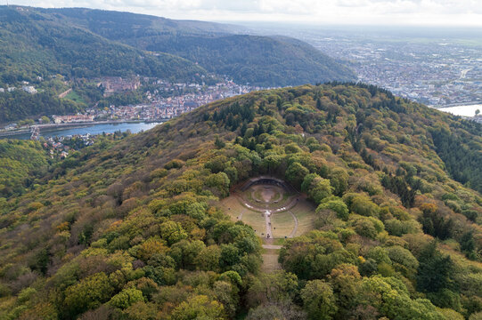 Aerial view of Thingst&Atilde;&curren;tte amphitheater nestled in the Odenwald forest, a verdant tapestry contrasting with the distant cityscape, Heidelberg Castle, Heidelberg, Baden-W&Atilde;&frac14;rttemberg, Germany.