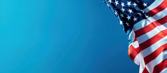 American flag waving against a bright blue sky