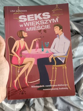 Hand Holding Polish Book "Seks w Większym Mieście" (Sex and the Greater City)