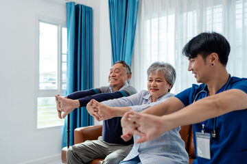 Fototapeta premium senior woman practices muscle strength exercises arms and hands instruct by physiotherapist. home caregiver nurse visit retire couple for health check up recovery process medical service