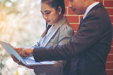 New employee working with laptop, training has been guided and consulting by colleagues. Selected focus