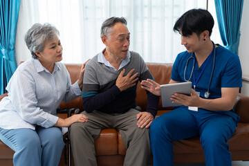 Obraz premium asian senior couple consult and discuss medical examination results with physiotherapist at clinic. home caregiver nurse visit retirement patient for health check up recovery process medical service