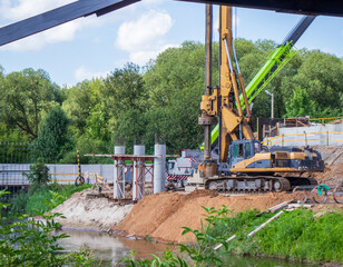 Heavy machinery used to dig a holes in a soil for bridge supports
