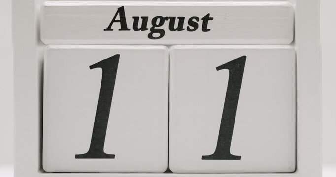 Wooden block calendar displaying the date August. Perfect for marking a significant day or event. Wooden Calendar Showing August Date on a White Background