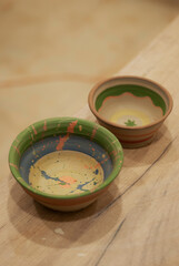 Painted details on handmade ceramic colourful plates