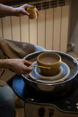 Painting handmade ceramics in a workshop